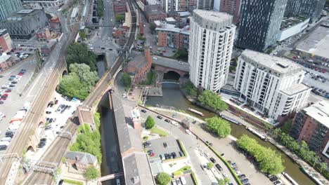 aerial drone flight over castlefield quays giving a revealing shot of manchester city centre