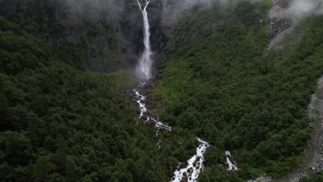 mardalsfossen waterfall in norway, aerial view of nature scenery of water dropping along mountain edge in forest