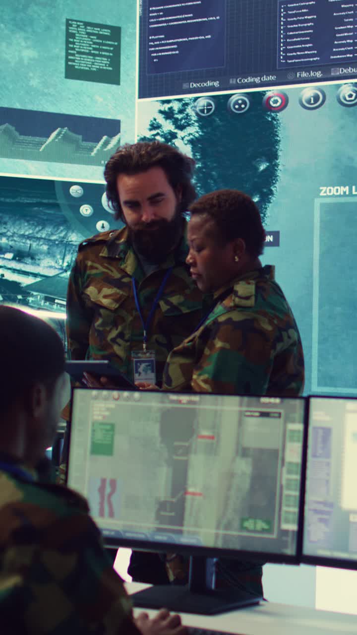 Military Analysts Discussing Data on Tablet in Control Room