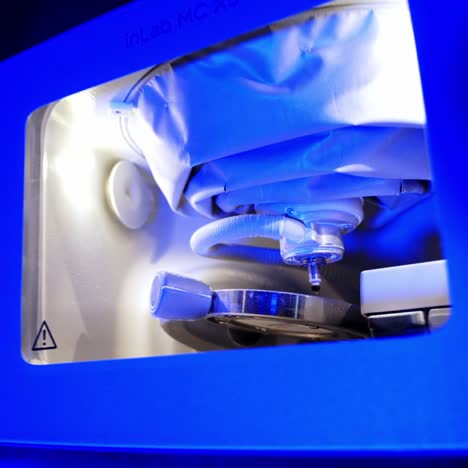 processing of carving out shape. highly productive automated dental milling machine working creating implants