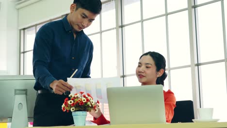 two business people talk project strategy at office