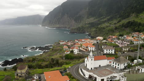 drone aeiral footage flying over seixal coastal town on north coast of madeira, portugal