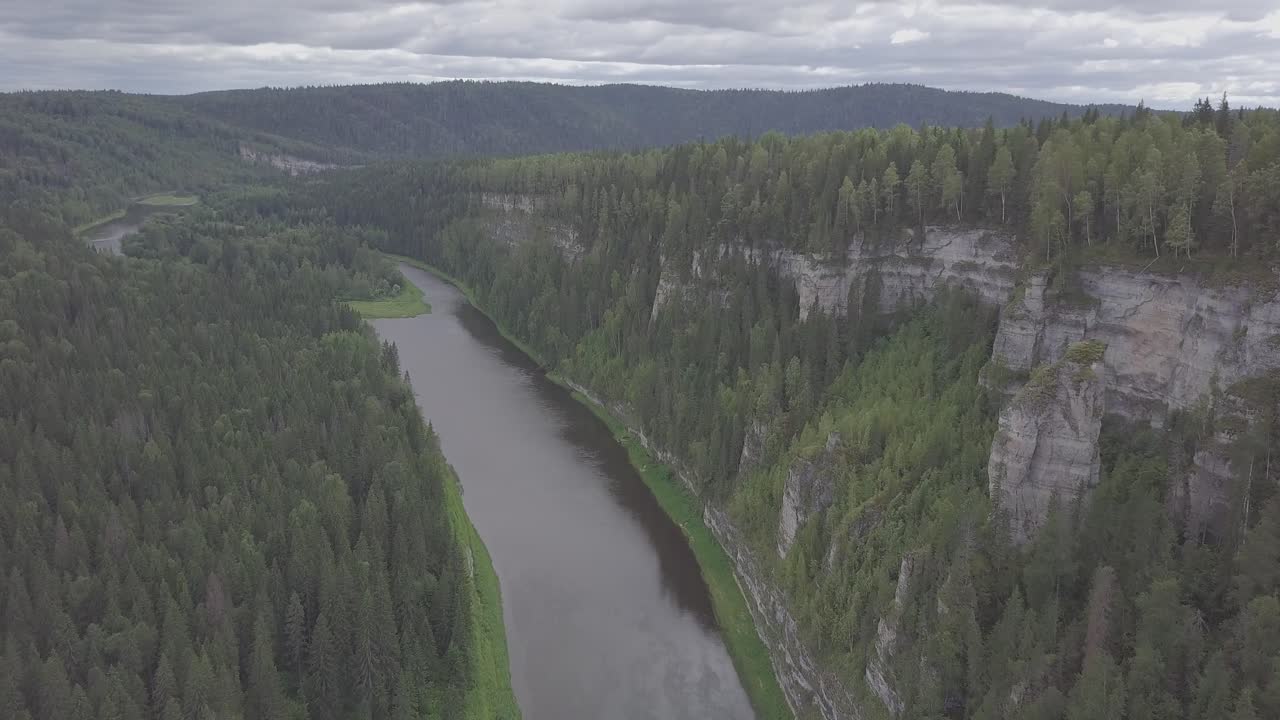 Ilmakuva joesta, joka halkoo vuoristometsää