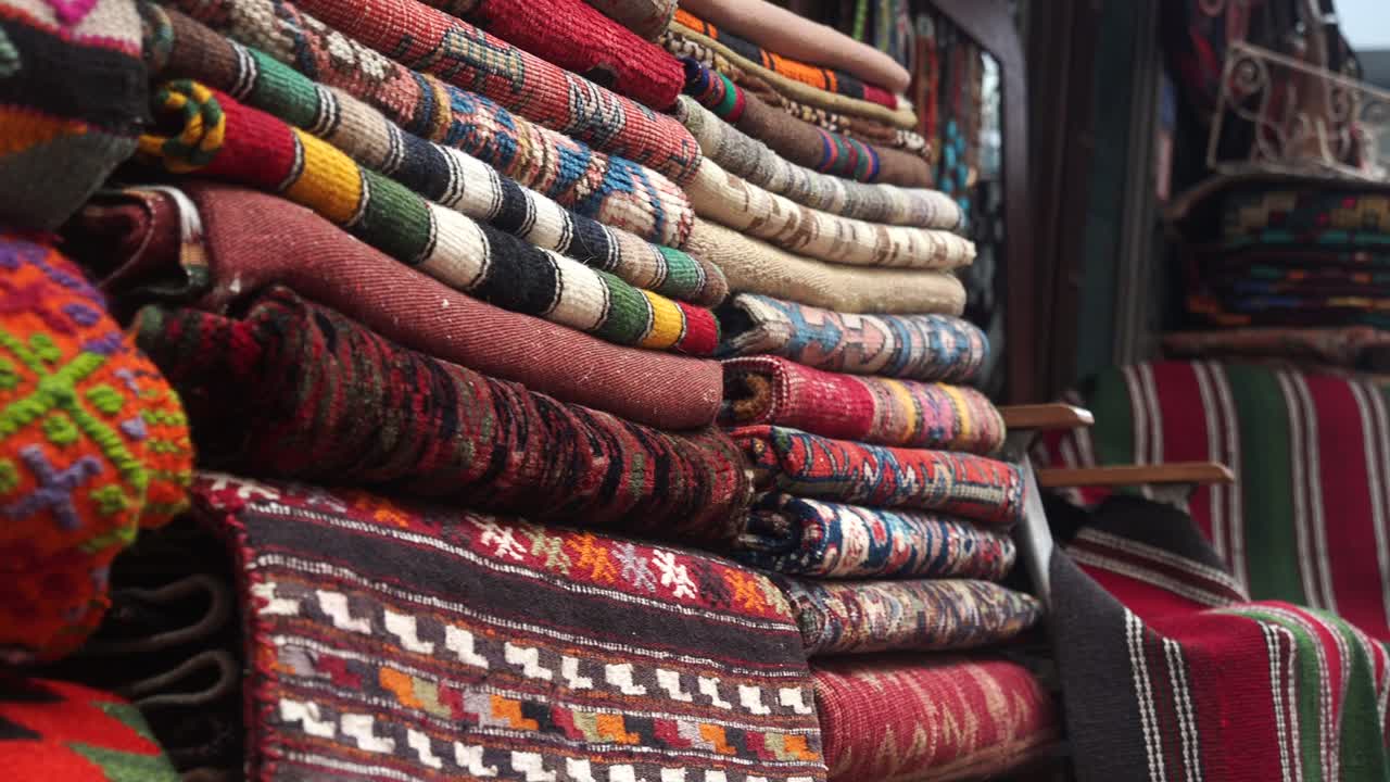 Colorful Handwoven Rugs and Textiles Displayed in a Shop