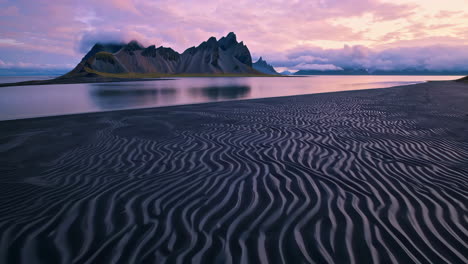 dramatic sunset over vestrahorn mountain and black sand beach in iceland