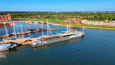 boats, ferries and ships at the berth in the port of lelystad, the netherlands. drone flight over the waterscape of lake merkemeer. view on the green panorama of the city.