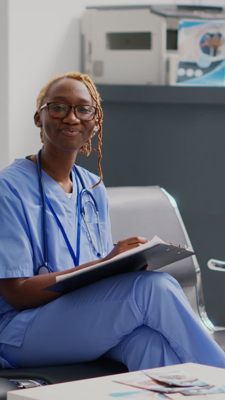 Vertical video: Female nurse reading medical reports papers in waiting room