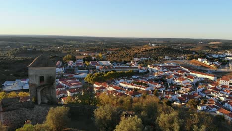 drone shot from by a medievel tower on a hill in alentejo, portugal