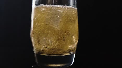 close up slow motion of soda being poured in ice