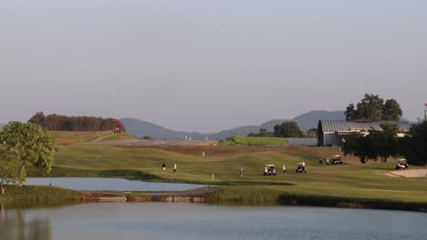 peaceful golf course with water hazard and clear sky