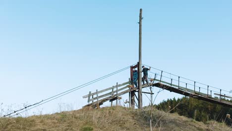 two people on a wooden bridge in rural landscape