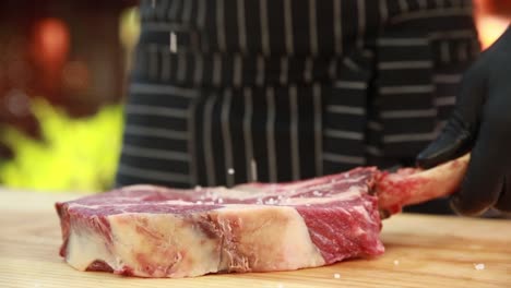 preparing a raw rib eye steak