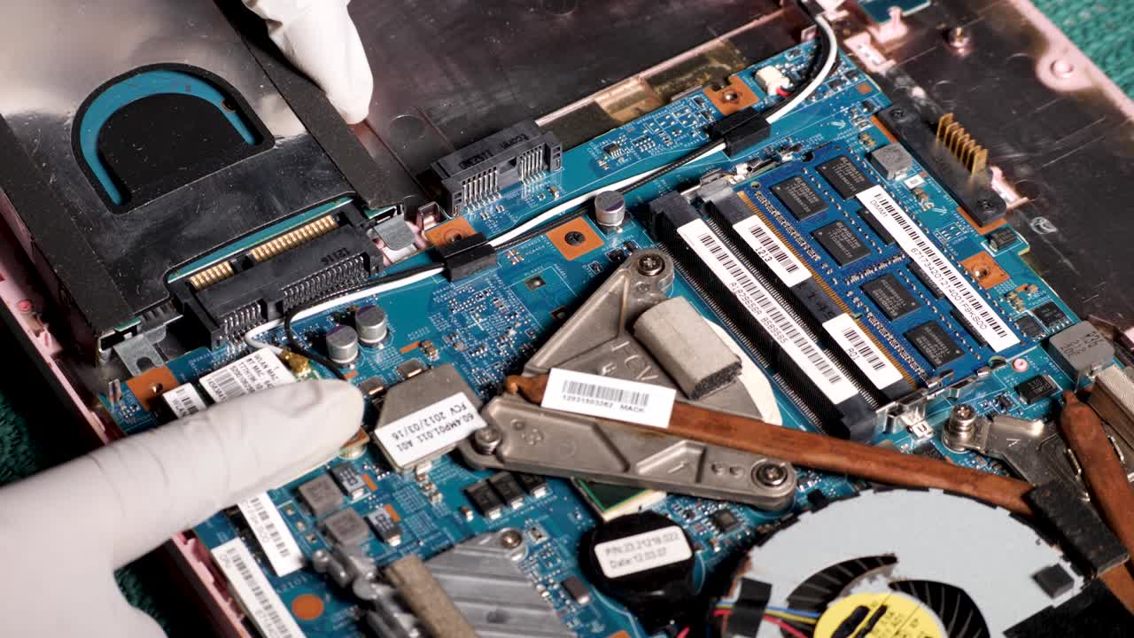 Latino Computer Technician With White Gloves Repair Laptop And Install Hard Drive