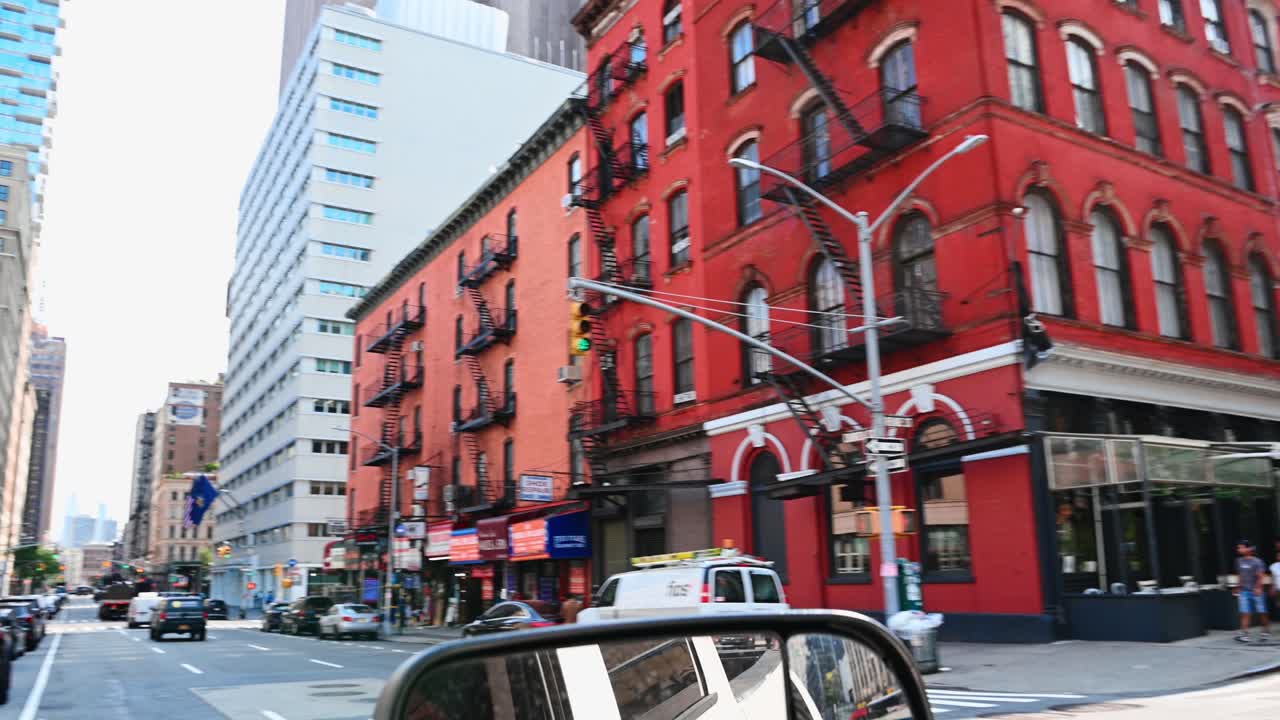 New York, USA, 5 August 2025: Street view of Manhattan buildings with emergency vehicle in motion. Urban street scene featuring multi-story buildings