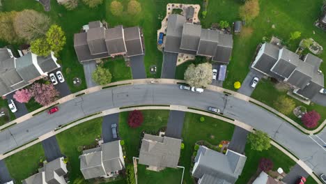 Aerial-top-down-shot-of-semi-detached-buildings-in-charming-neighborhood-in-spring