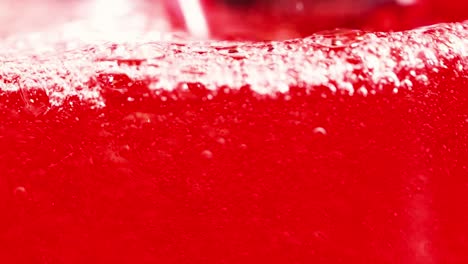 a detailed view of vibrant red bubbles rising and swirling in a liquid environment.