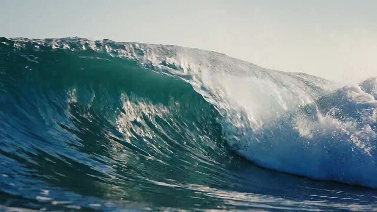Majestic cresting ocean wave in deep blue water