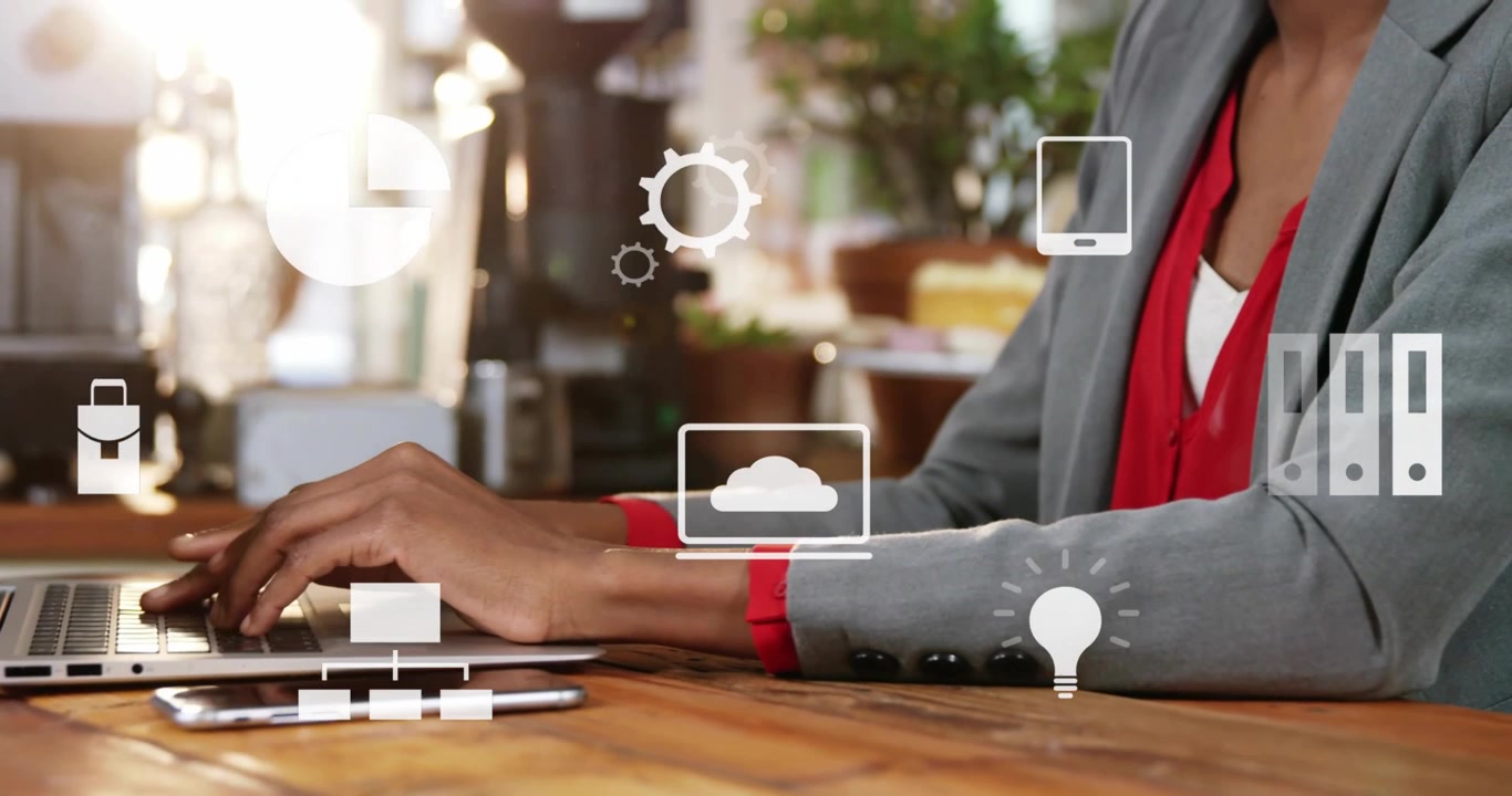 Woman typing on laptop making floating phone chart icons around hands showing tech flow cam moving