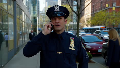 police officer talking on phone in city