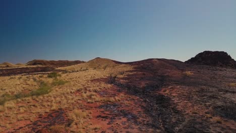 aerial drone elevating over vast australian desert after bushfire