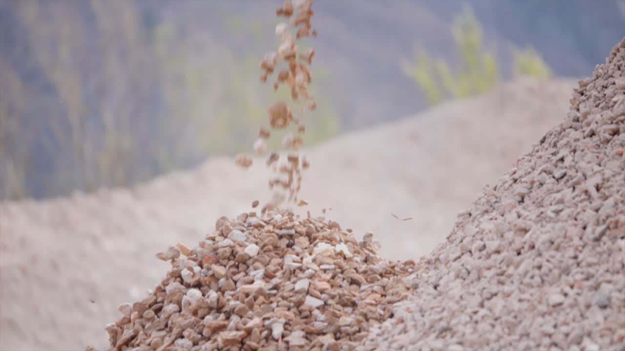 Close-up view about the falling rocks debris in mining quarry until the end.