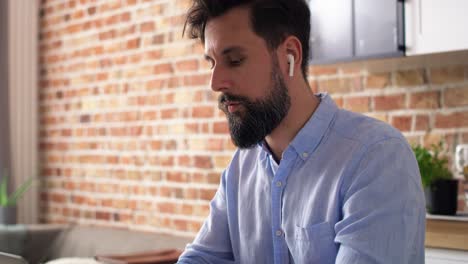 Handheld-video-of-man-working-using-laptop-at-home