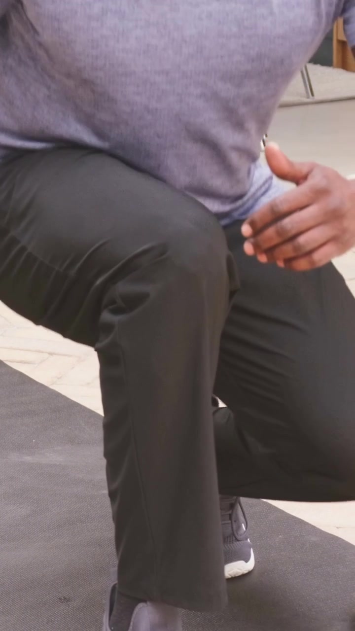 Vertical video: Starting near sliding door on patio, man stepping on mat, lunging, training, watch