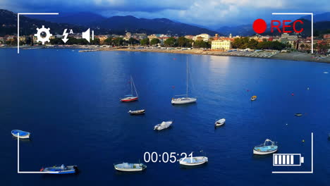boats anchored in calm sea with video recording animation overlay