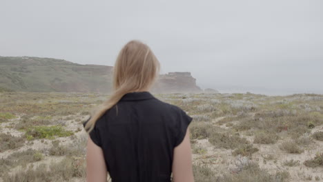 woman walking on a coastal path