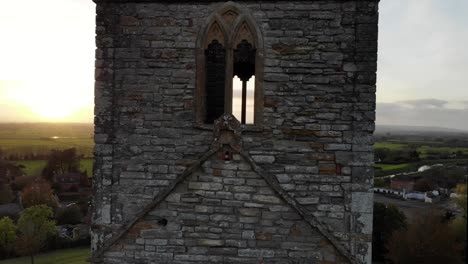 aerial downwards shot of the church at burrow mump somerset england with the sunset in the background