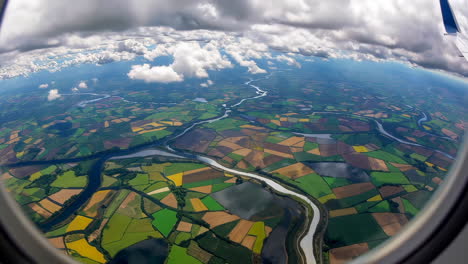 aerial view of farmland and rivers from an airplane window