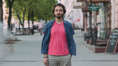 man standing on city street