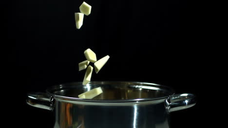 chopped parsnip falling into saucepan