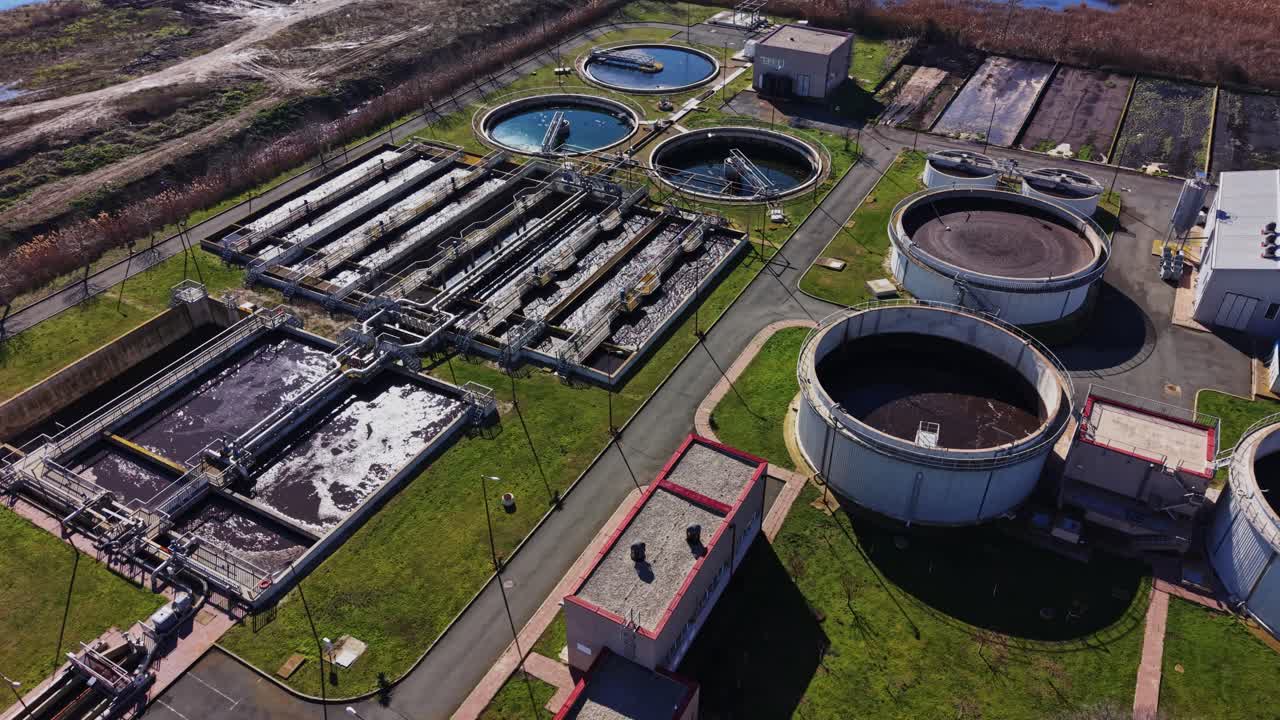Water treatment facility in operation with many tanks and buildings