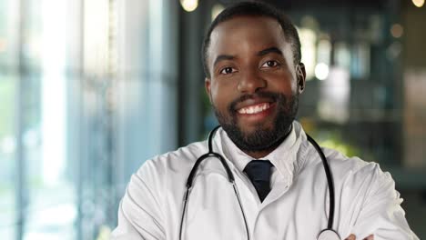 portrait of african american doctor with stethoscope looking at camera and smiling cheerfully