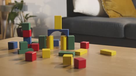 colourful wooden building blocks on table at home for learning and child diagnosed with asd 1