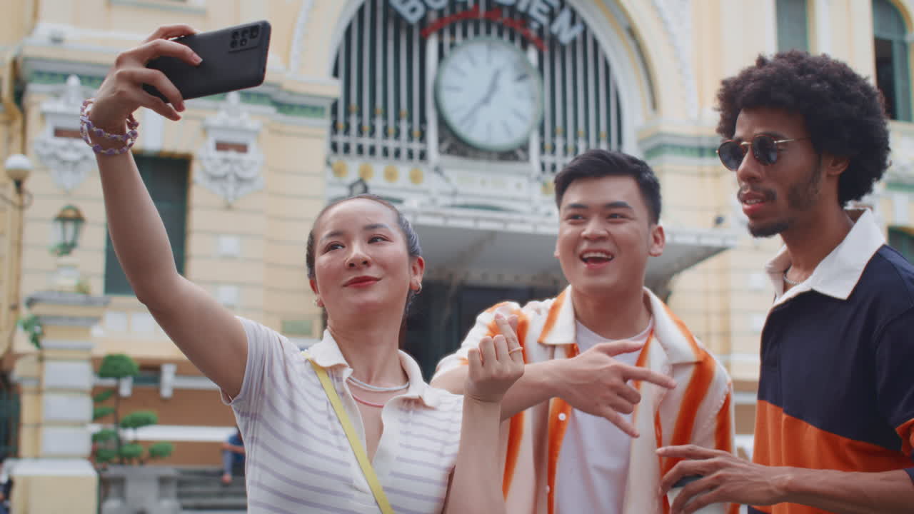 Group of Friends Posing for Selfie Using Smartphone in City