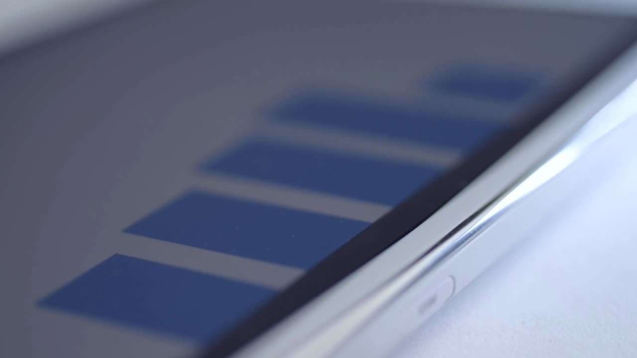 Blue sales graph report on a tablet close up shot