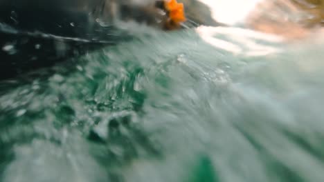 deep green water texture on side of boat sailing on mountain river with high speed