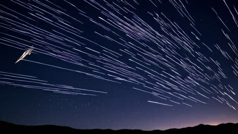 star trails over mountains at night