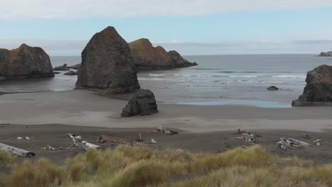 aerial of rugged picturesque beach and small islands of rock off the pacific ocean in oregon