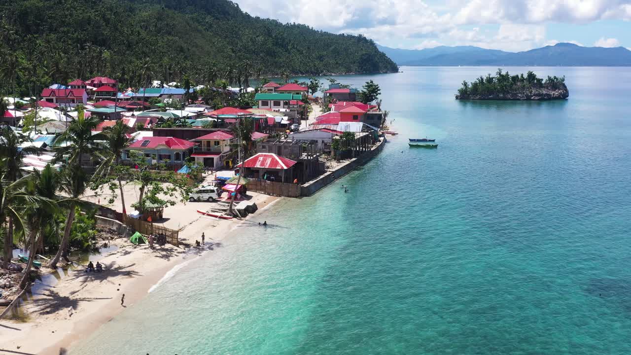 Tropical Beach, Seaside Village, and Island with Clear Water At Summer In The Philippines. - aerial