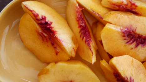 closeup of freshly sliced peaches in a bowl