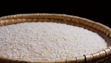 rice seed on rotating display on wood bowl