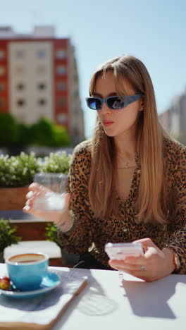 young woman using a phone in a cafe