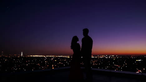 couple on rooftop at sunset