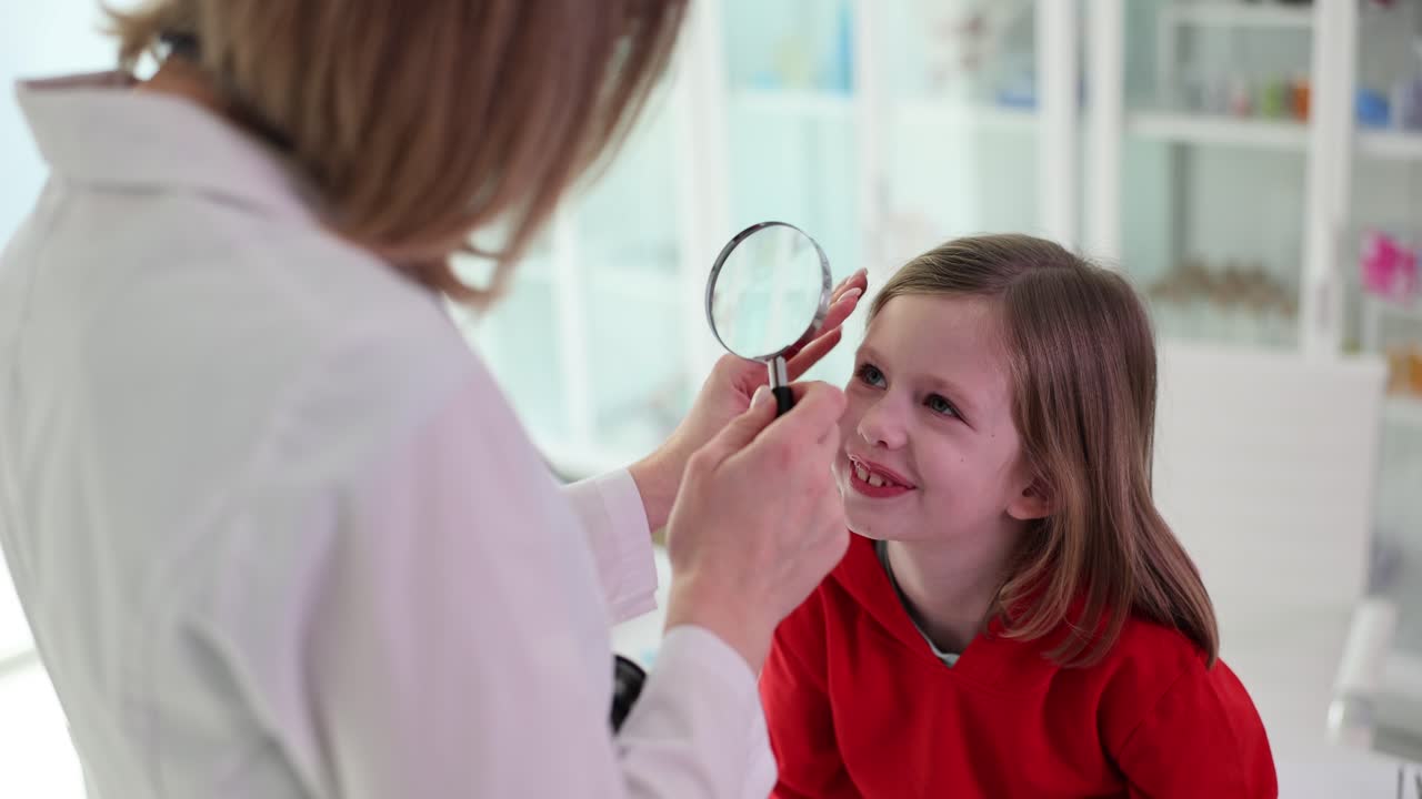 Doctor examines a child's eye with a magnifying glass