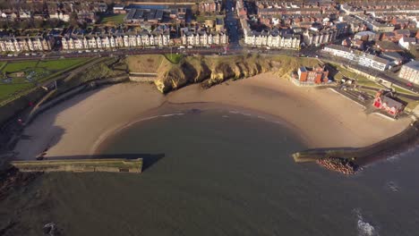 aerial view looking down onto cullercoats beach on quiet spring morning - north tyneside coastline