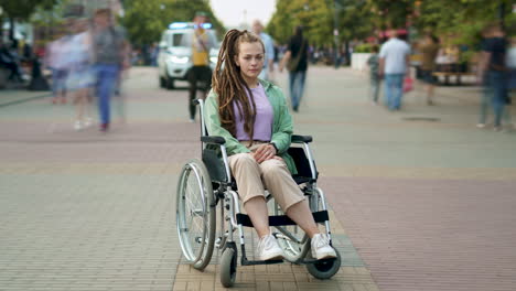 woman in wheelchair in city park