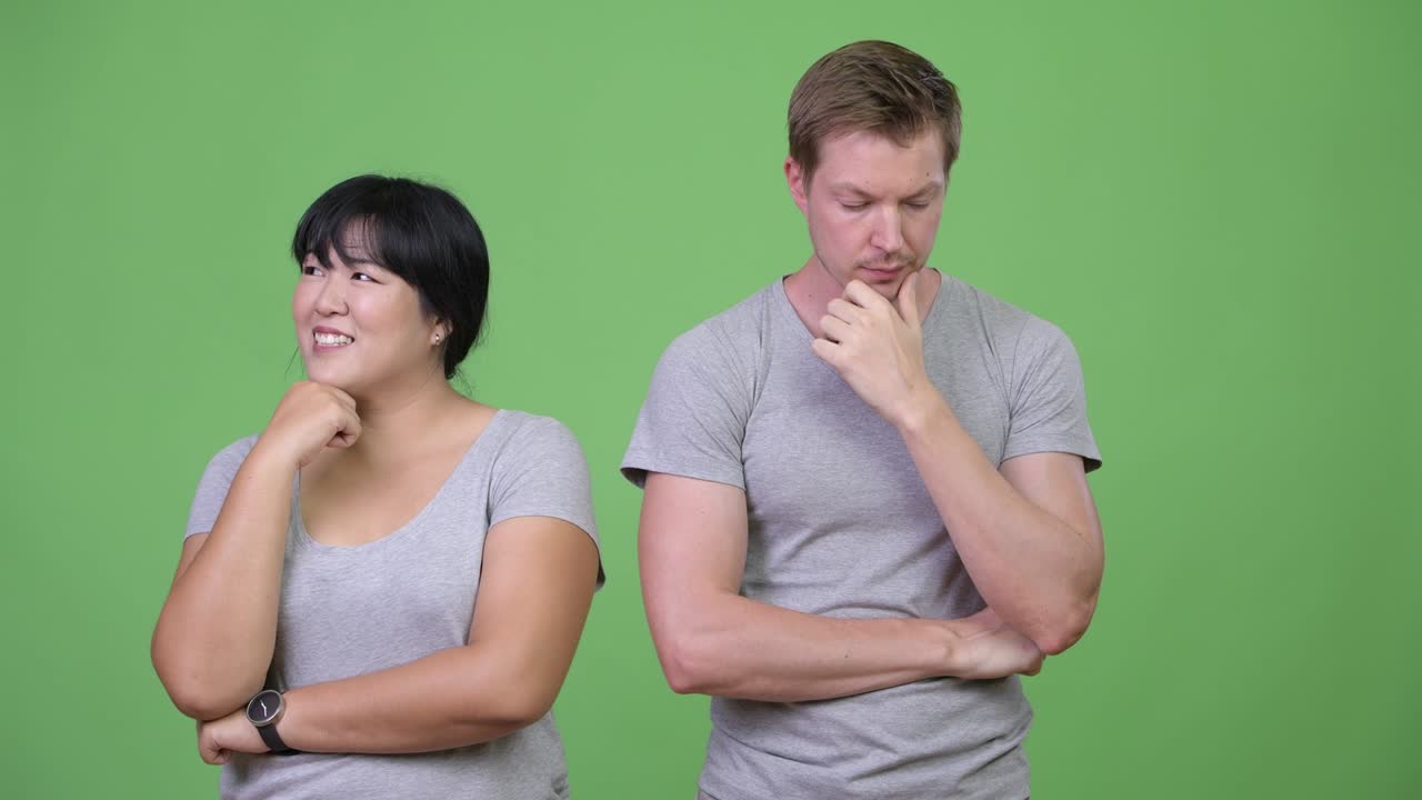 Young multi-ethnic couple thinking differently together